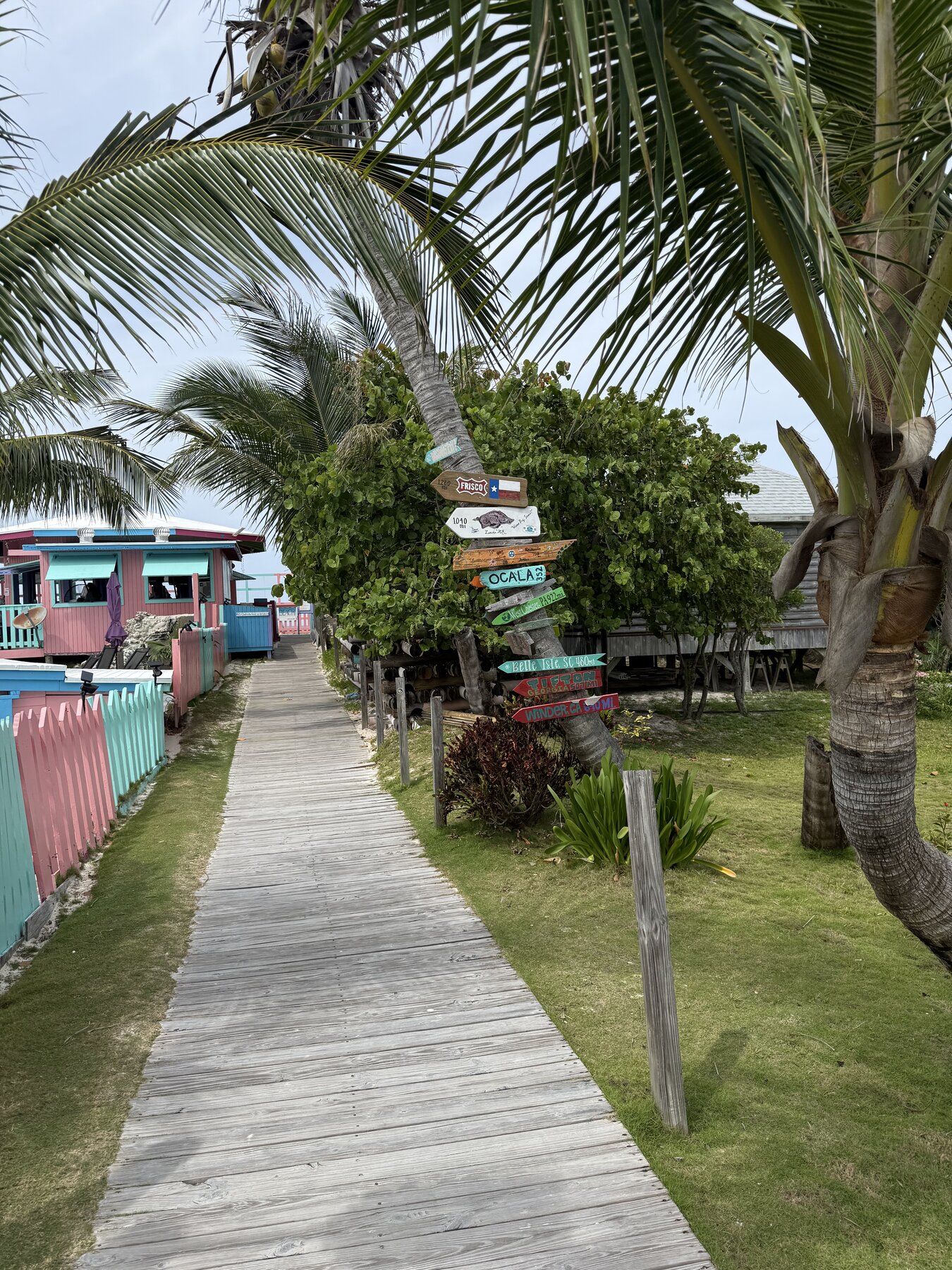 Treasure Cay boardwalk and palm-lined signpost